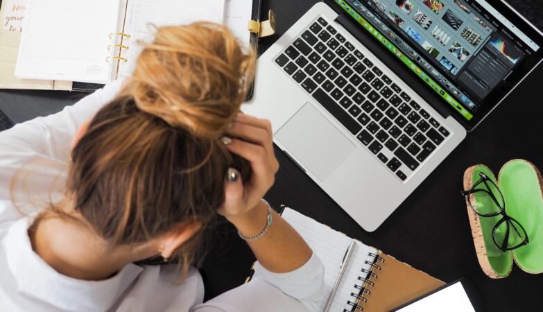 woman sitting in front of macbook